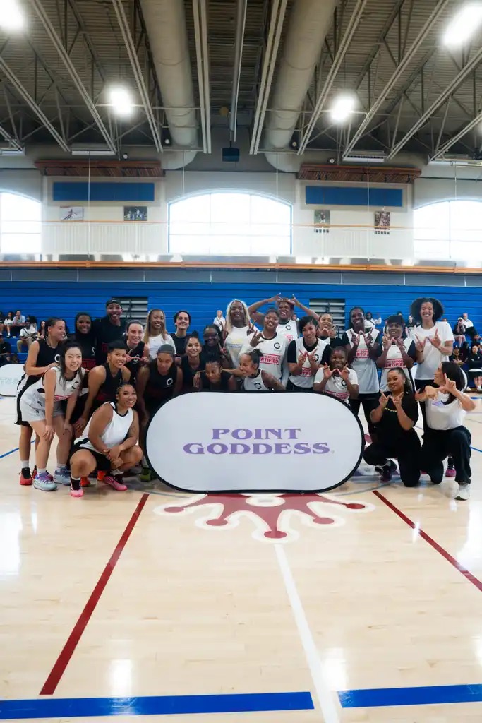 Families and players together in the gym at a Point Goddess celebrity game