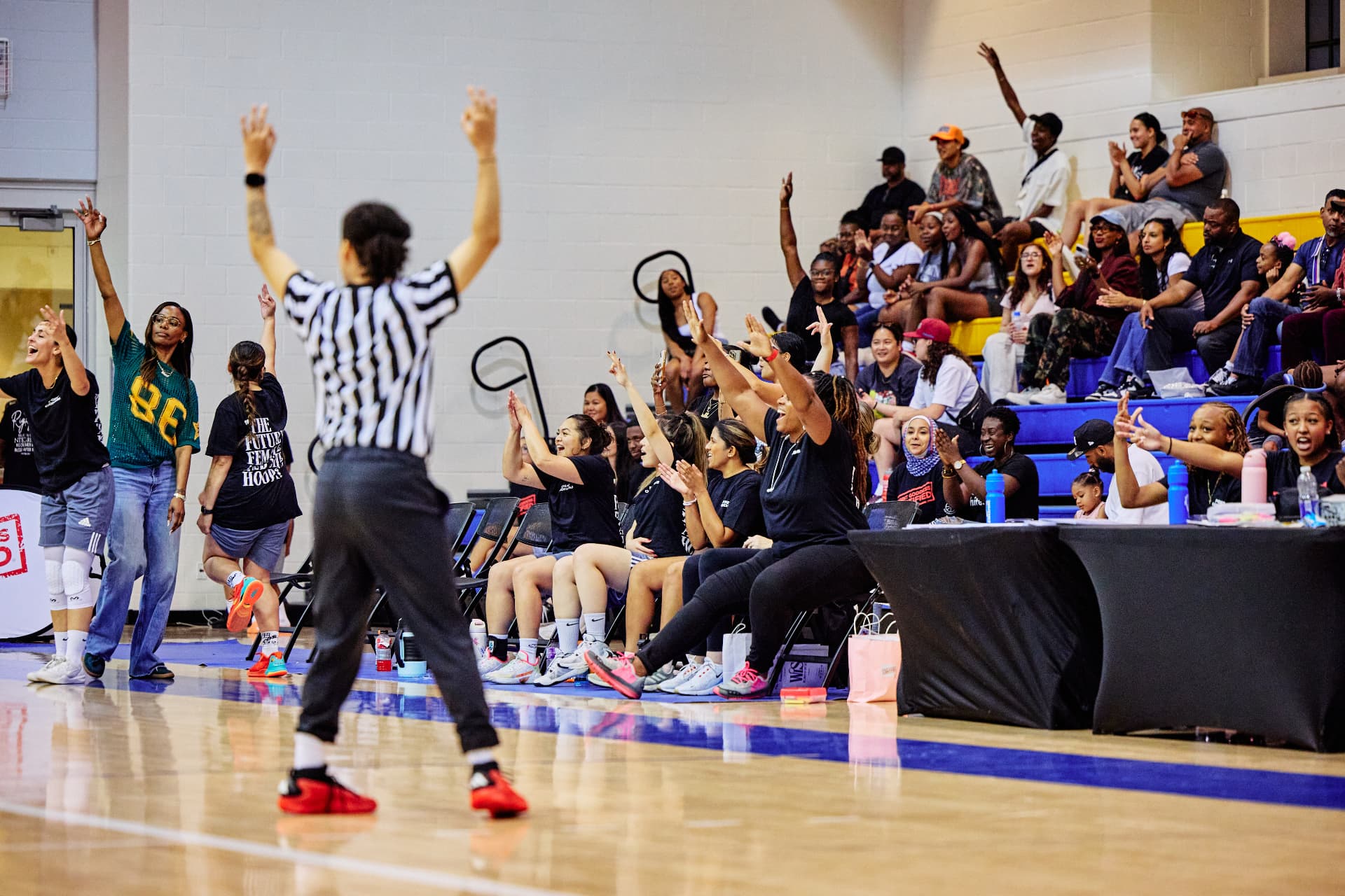 Crowd and bench celebrating at the Point Goddess Celebrity Game