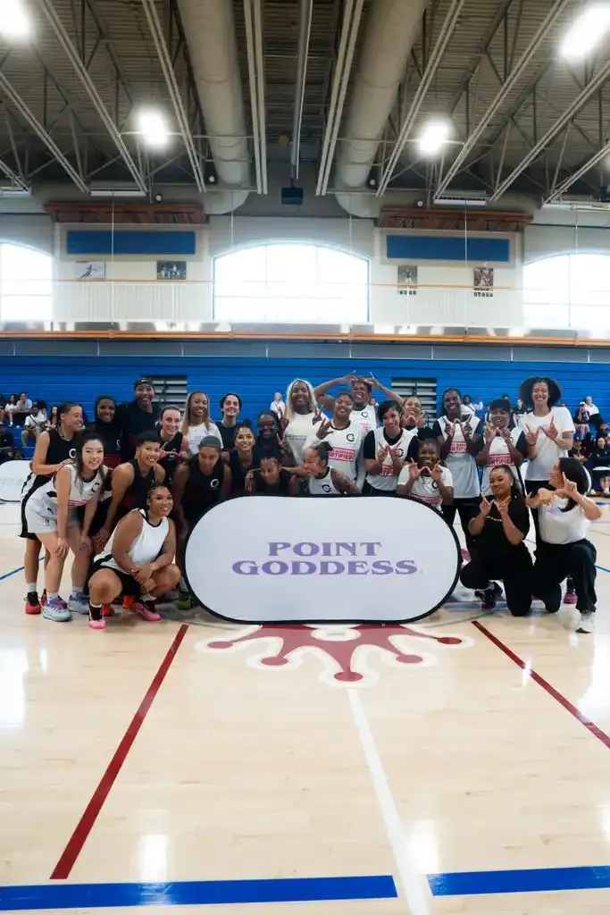 Families and players together in the gym at a Point Goddess celebrity game
