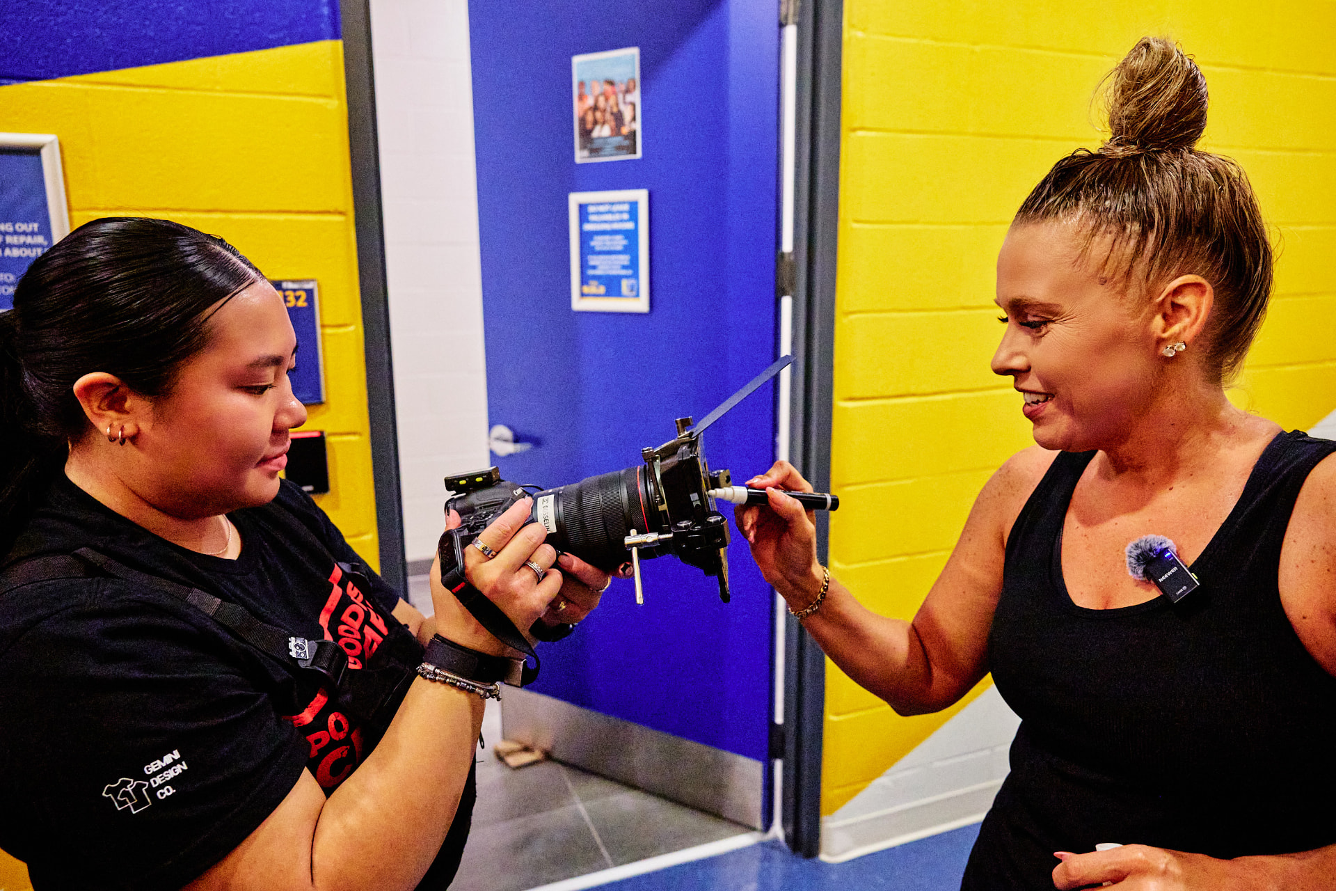 A photographer showing the back of her camera to a Point Goddess team member